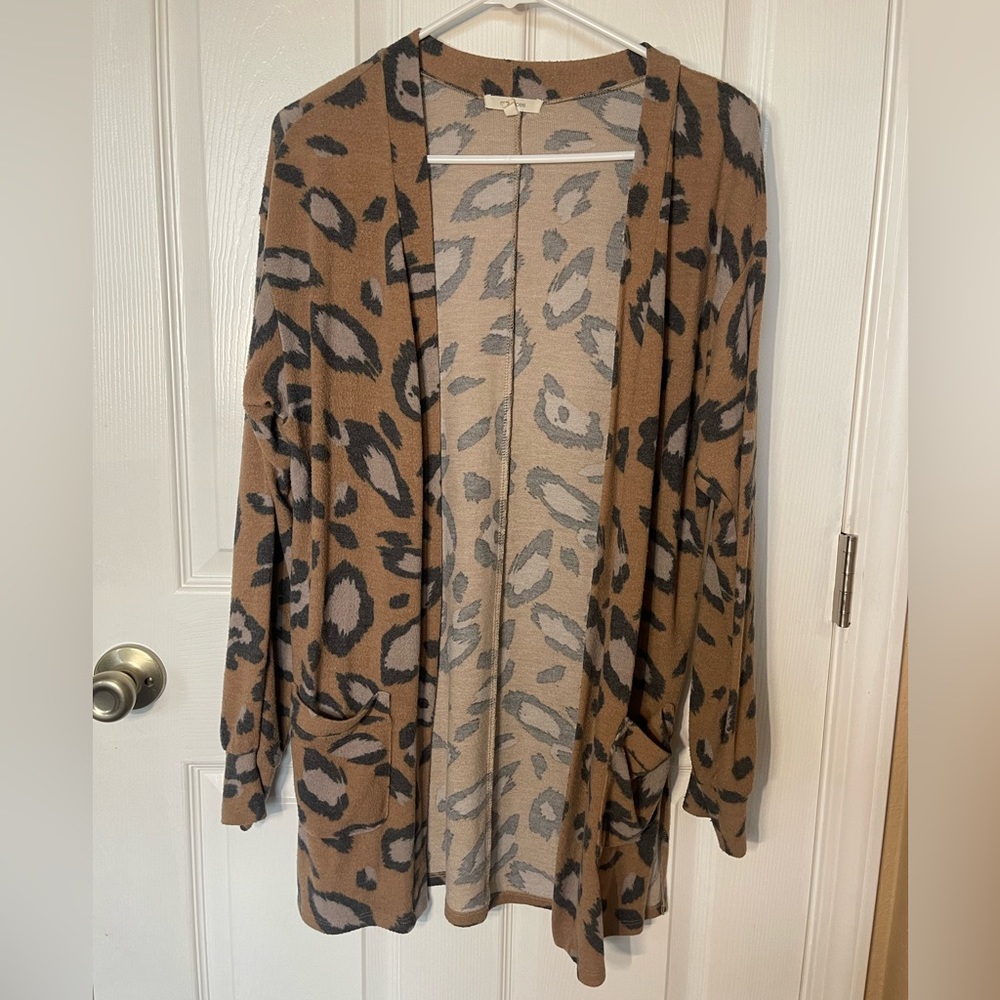 Cheetah print cardigan in size small. Pockets in front and 2 slits in back